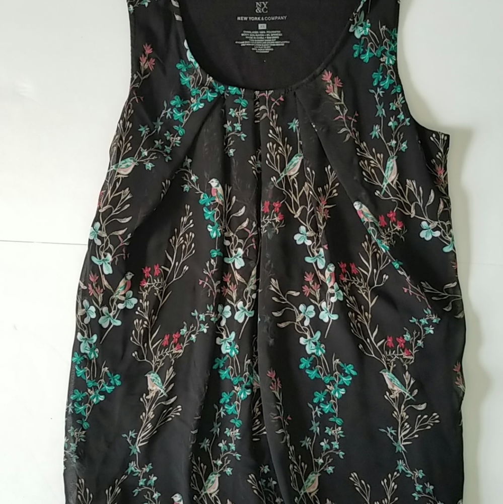 Dressy tank top with pleated neck.